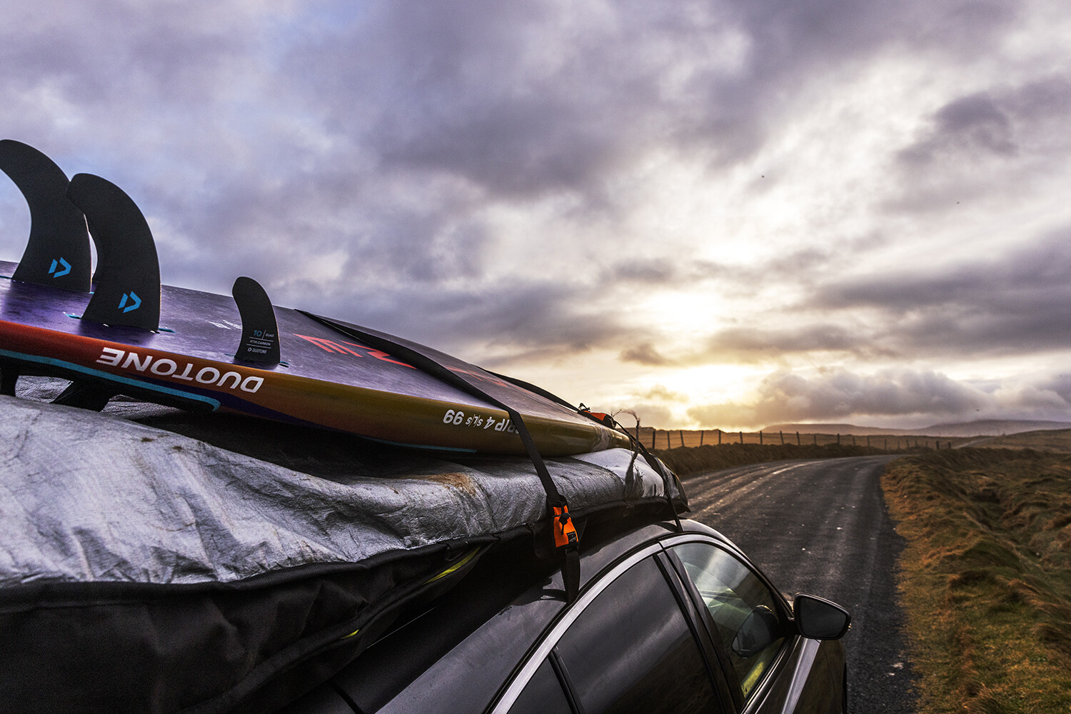 Windsurf gear strapped to the car roof