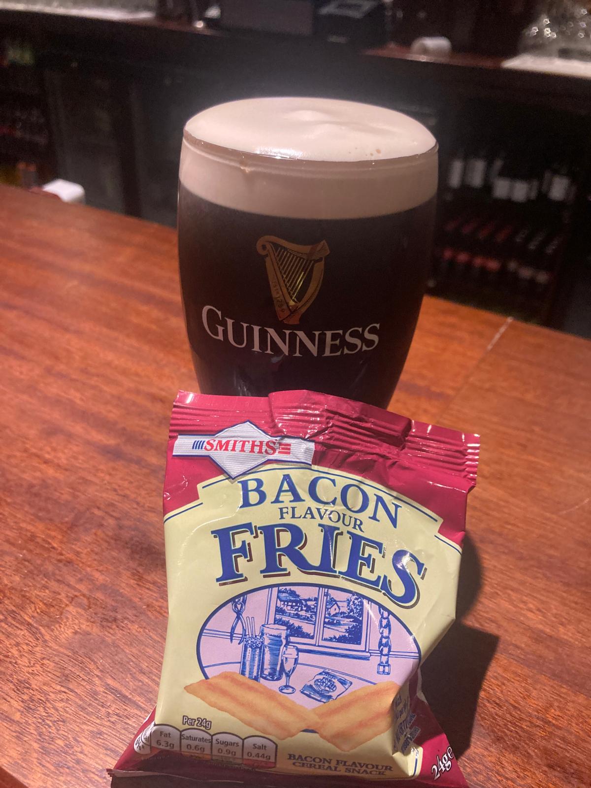 A pint of Guinness and bacon fries after a session in Ireland